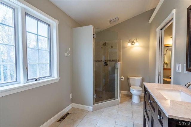 bathroom with a wealth of natural light, visible vents, a stall shower, and toilet