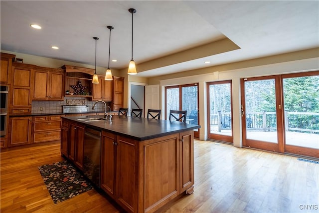 kitchen with visible vents, brown cabinets, a sink, open shelves, and dark countertops