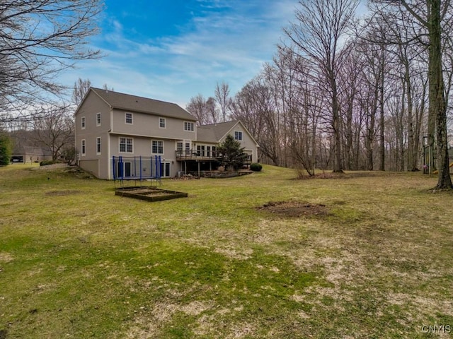 back of house with a wooden deck and a yard