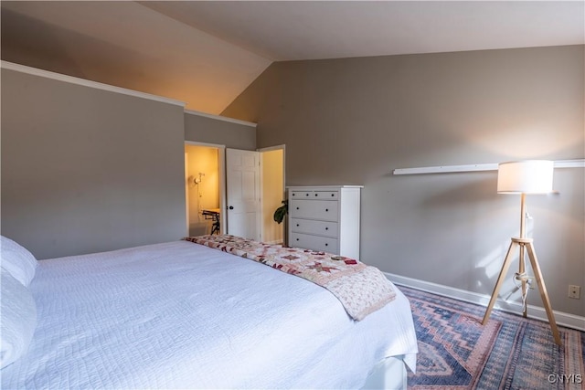 bedroom with baseboards and vaulted ceiling