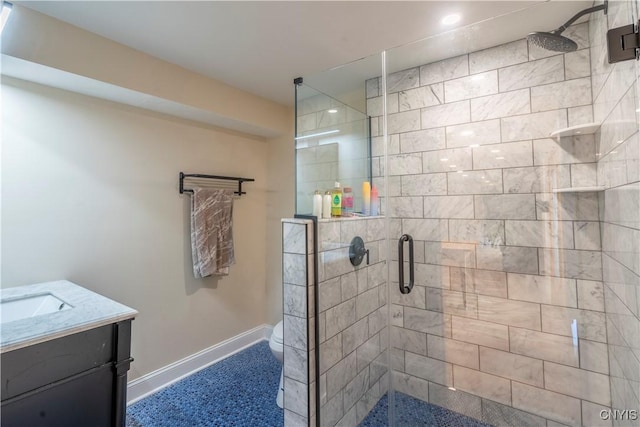 full bathroom featuring toilet, a stall shower, vanity, and baseboards