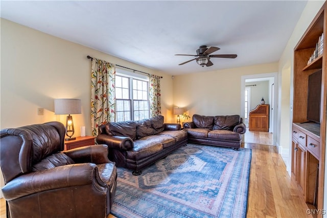 living area featuring a ceiling fan and light wood-style floors