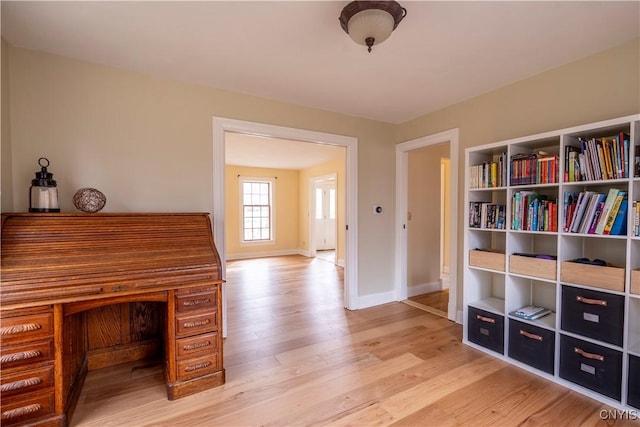 office space with wood finished floors and baseboards