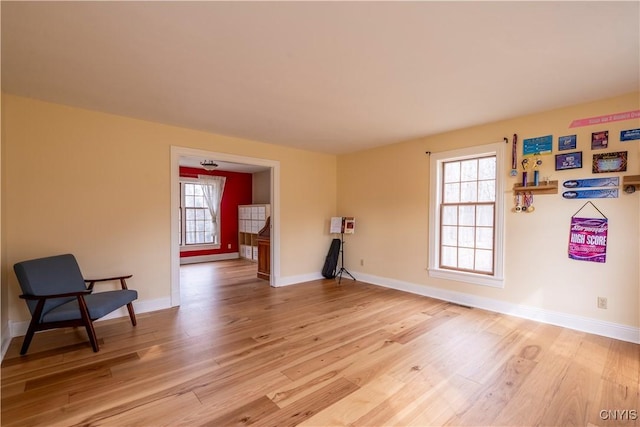 unfurnished room featuring light wood-style flooring and baseboards