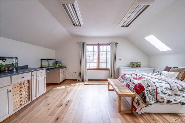 bedroom with baseboards, light wood-style floors, and vaulted ceiling