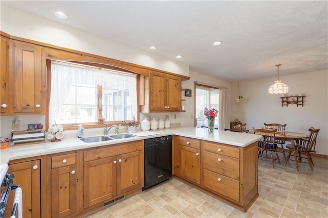 kitchen featuring a peninsula, a sink, light countertops, black dishwasher, and brown cabinets