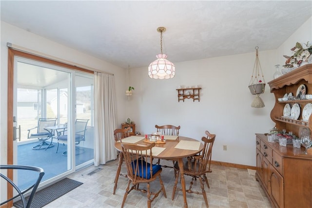 dining room featuring visible vents, baseboards, and light floors