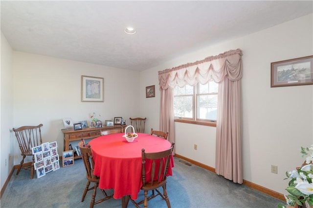 carpeted dining area featuring visible vents and baseboards