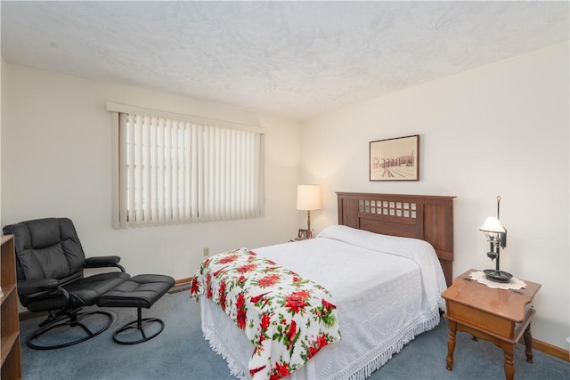 bedroom with baseboards, a textured ceiling, and carpet