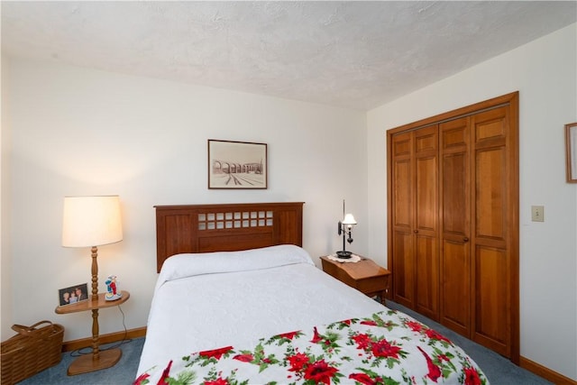 carpeted bedroom featuring a closet, baseboards, and a textured ceiling