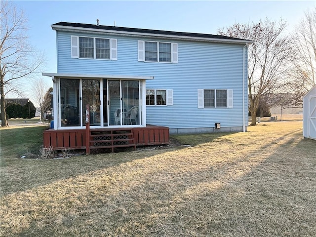 rear view of house with a lawn and a sunroom