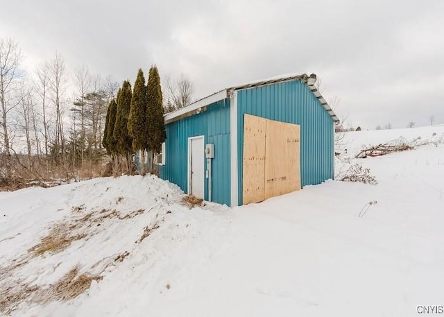 snow covered structure featuring an outdoor structure