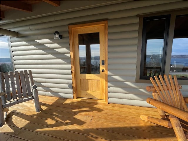 doorway to property featuring log veneer siding