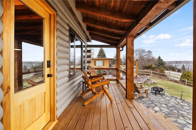 deck featuring a fire pit and fence