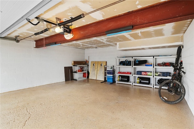 garage with concrete block wall and a garage door opener