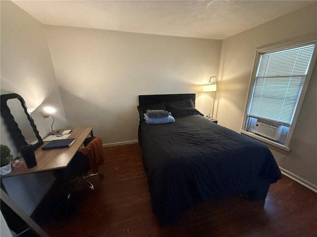 bedroom with baseboards and wood finished floors