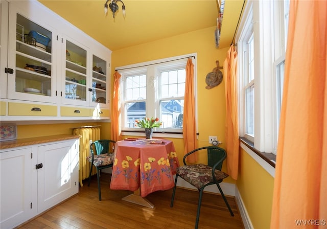 dining room featuring light wood-type flooring and baseboards