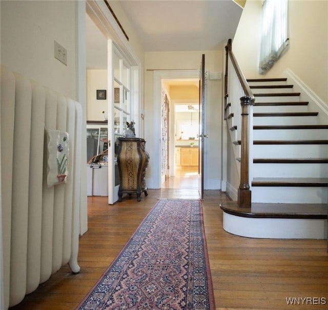 foyer featuring hardwood / wood-style floors and stairs