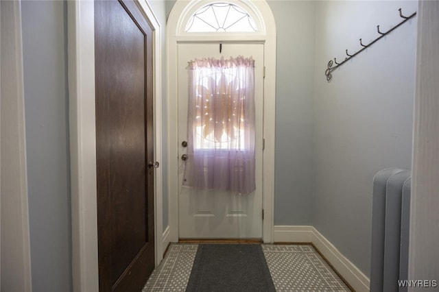 doorway to outside featuring baseboards