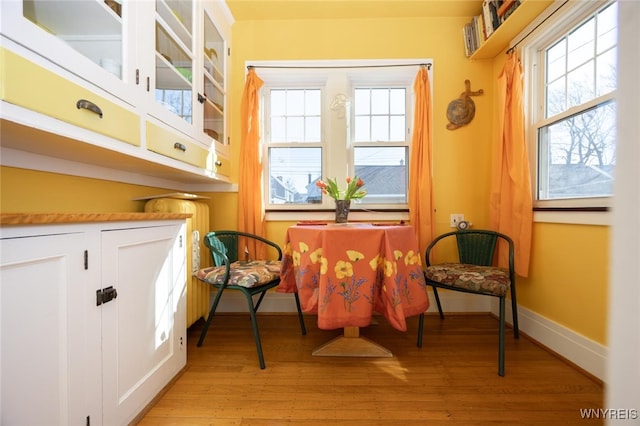 dining area featuring baseboards and light wood-type flooring