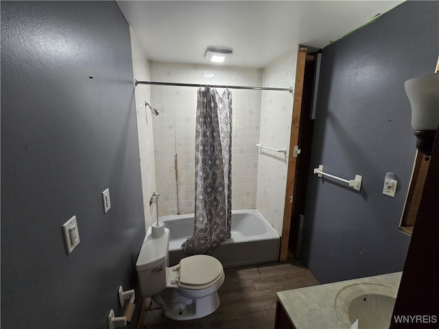 bathroom with wood finished floors, toilet, shower / bath combo, and vanity