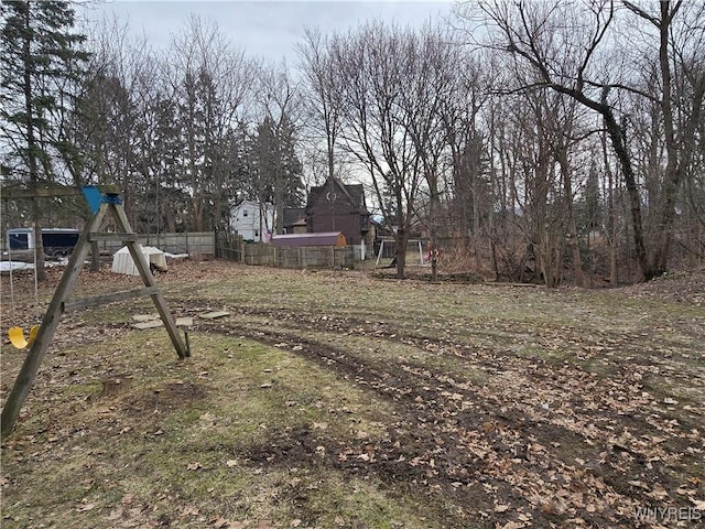 view of yard featuring a playground and fence