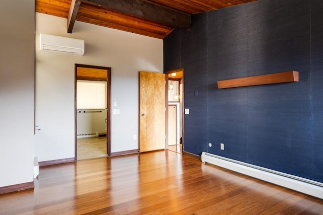 spare room featuring wood finished floors, a baseboard radiator, a wall mounted AC, beam ceiling, and a baseboard heating unit