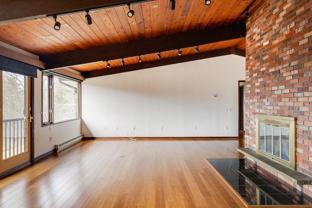 unfurnished living room with hardwood / wood-style floors, a baseboard radiator, a fireplace, rail lighting, and wooden ceiling