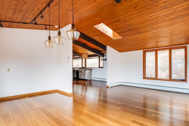 unfurnished living room featuring a baseboard heating unit, vaulted ceiling with skylight, wood ceiling, and wood finished floors