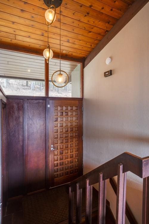 stairs featuring wooden ceiling and vaulted ceiling