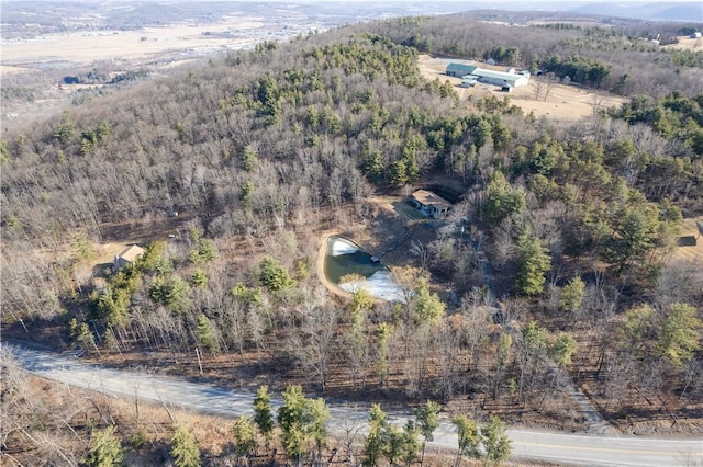 drone / aerial view with a wooded view