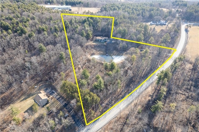 birds eye view of property with a view of trees