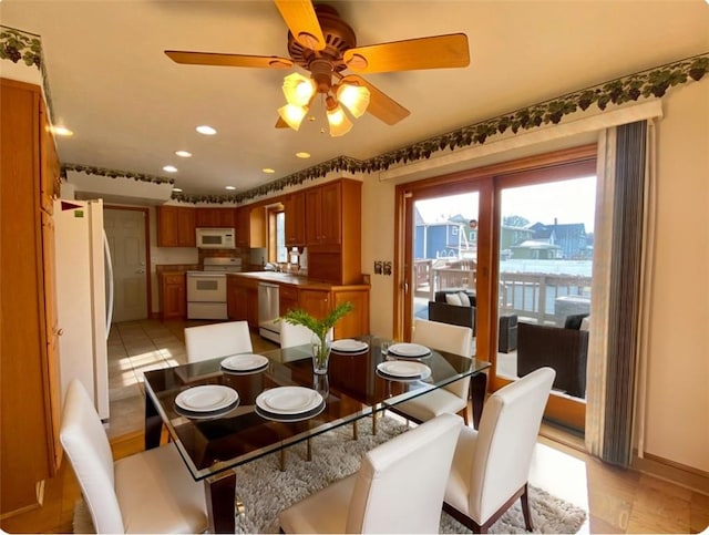 dining space with light tile patterned floors and recessed lighting