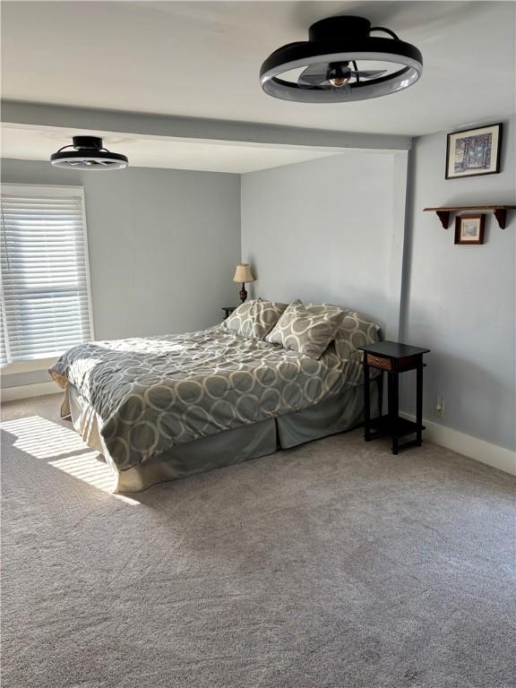 bedroom featuring carpet flooring and baseboards