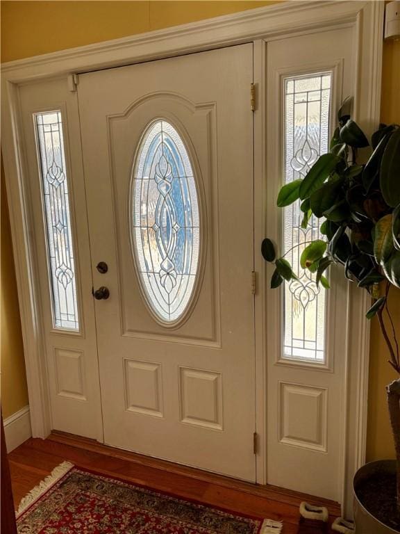 entryway with wood finished floors