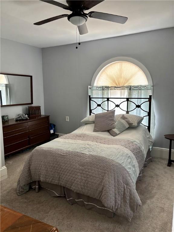 bedroom featuring carpet, baseboards, and ceiling fan