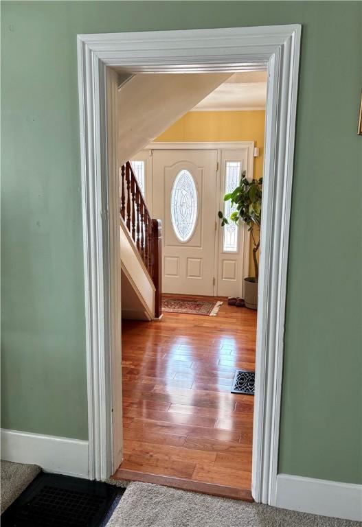 entrance foyer featuring wood finished floors and stairs