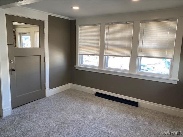 empty room with visible vents, ornamental molding, recessed lighting, carpet floors, and baseboards