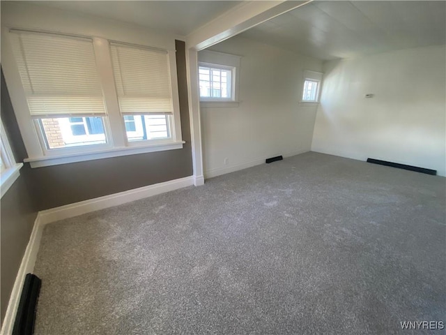 carpeted spare room with baseboards