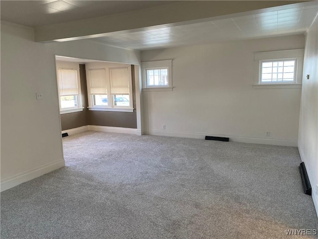 unfurnished room featuring carpet flooring and baseboards