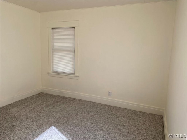 unfurnished room featuring baseboards and carpet flooring