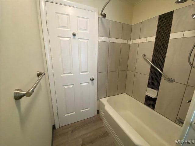 bathroom with tub / shower combination and wood finished floors