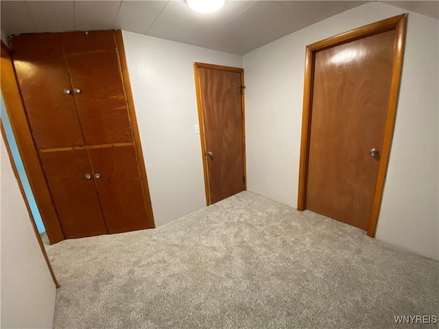 unfurnished bedroom with a closet and carpet floors