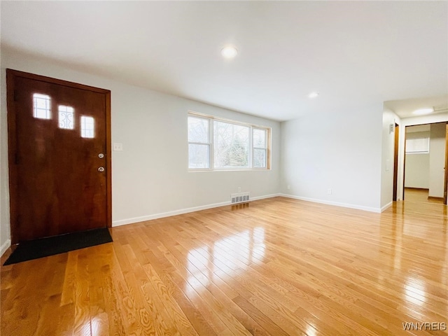 foyer with visible vents, baseboards, and light wood-style floors