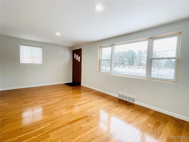 unfurnished room featuring light wood-style flooring, recessed lighting, baseboards, and visible vents