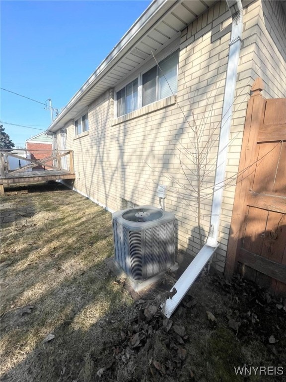 view of property exterior featuring brick siding and central AC unit