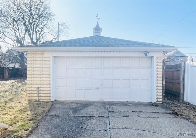 detached garage featuring fence