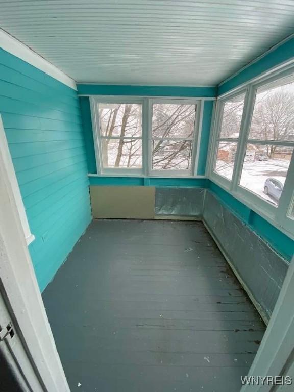 unfurnished sunroom featuring a wealth of natural light