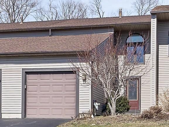 view of front of property featuring a garage and aphalt driveway