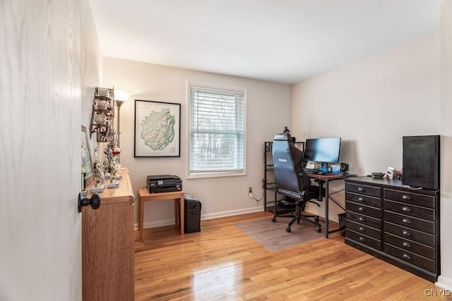 office area with light wood-type flooring and baseboards